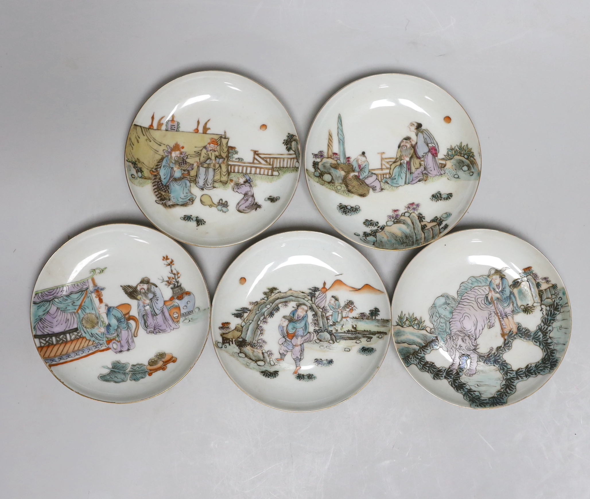 A set of five Chinese enamelled porcelain saucer dishes, decorated with figures and elders, each 13cm in diameter